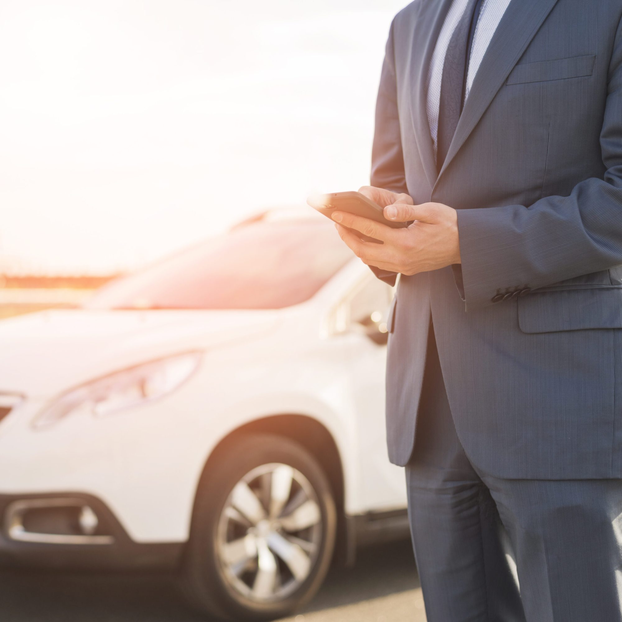 businessman-with-smartphone-front-car (1)